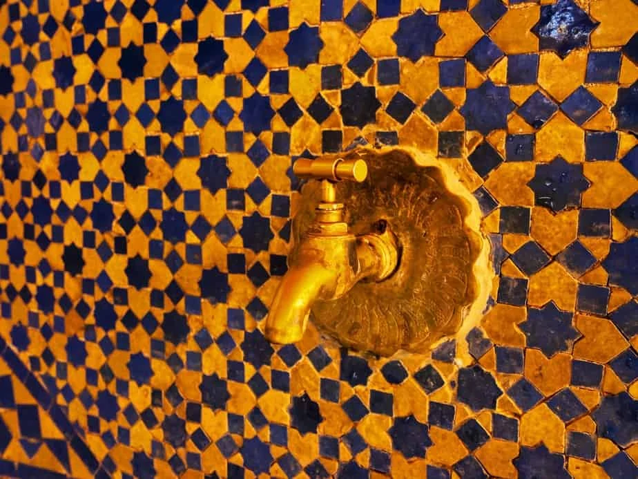 Golden Tap and Tiled Wall in Fes, Morocco